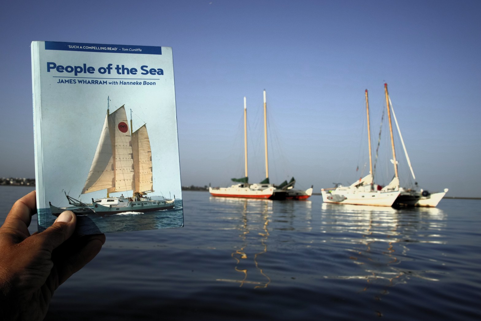 People of the Sea book cover, two boats (Spirit of Gaia and Blues) in the background